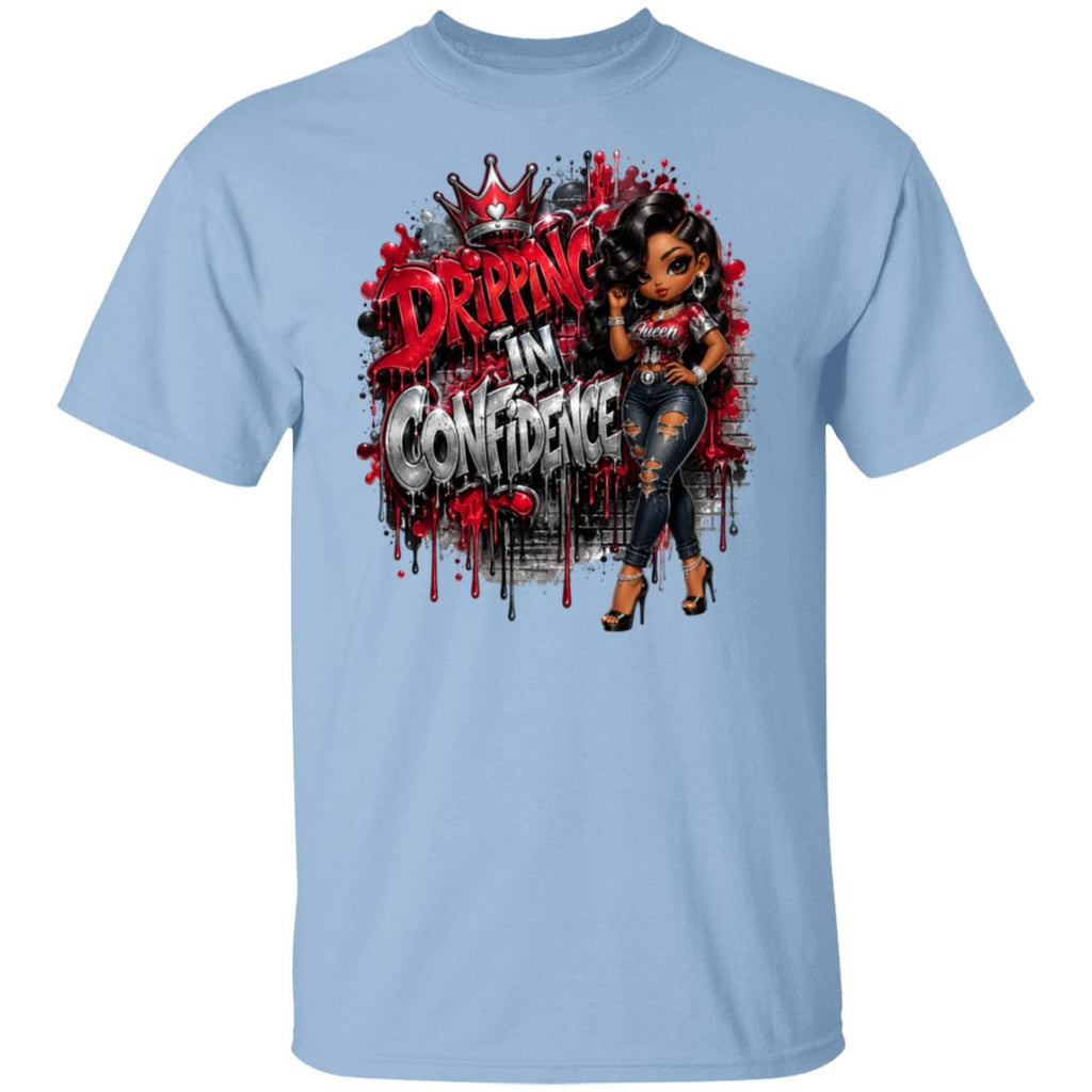 A light blue crewneck t-shirt featuring a large graphic print on the front. The graphic displays the text 'DRIPPING IN CONFIDENCE' in a stylized red and white font with a dripping paint effect, alongside an illustration of a woman with dark hair wearing a red and white top and distressed blue jeans.