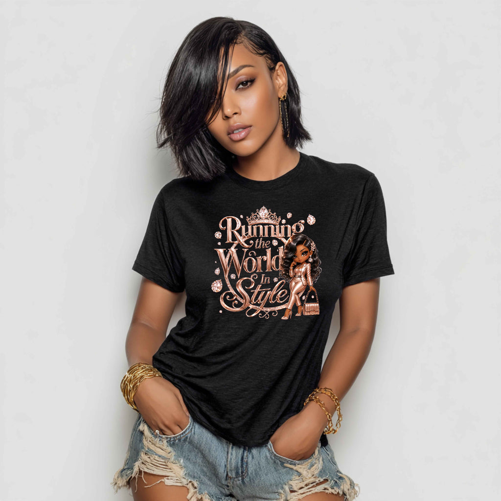 A woman wearing a black graphic t-shirt with a rose gold and white print that reads 'Running to the World in Style' alongside an illustration of a woman, paired with distressed denim shorts.