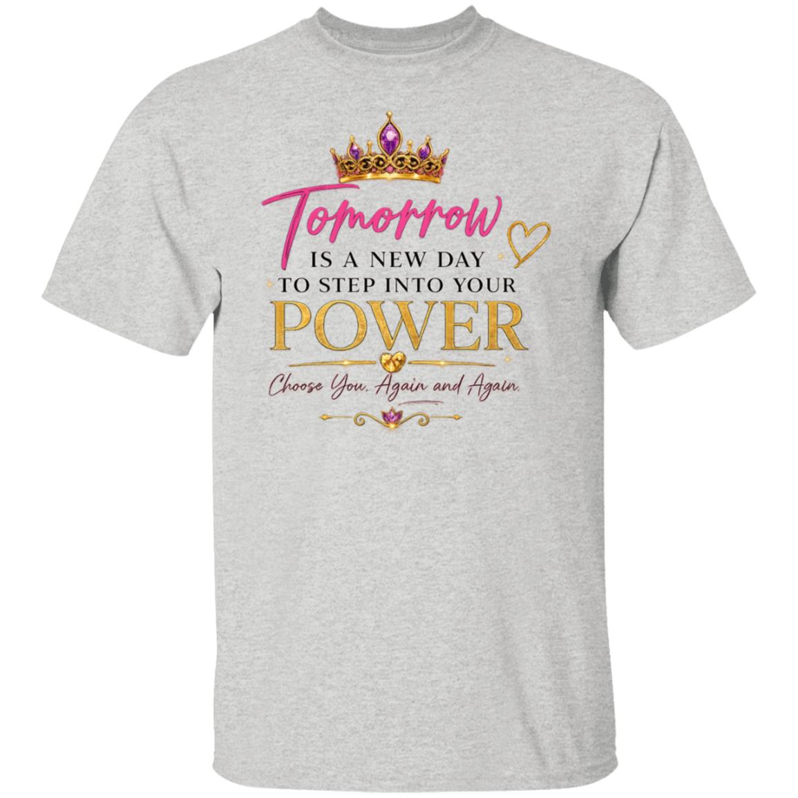 A light heather gray short-sleeve t-shirt with a graphic print on the front. The design features a gold crown, pink and gold text reading 'Tomorrow IS A NEW DAY TO STEP INTO YOUR POWER Choose You.