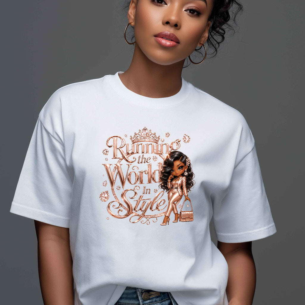 A woman wearing a white crewneck t-shirt with a graphic print that reads 'Running the World In Style' in a rose-gold/copper tone, featuring an illustration of a woman in a bikini. The background is a solid dark gray studio backdrop.